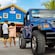 Two Guests standing next to a Jeep in front of Bahama Grill Café